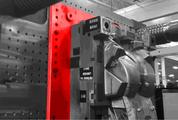 black and white photo of manufacturing machine components highlighted in red